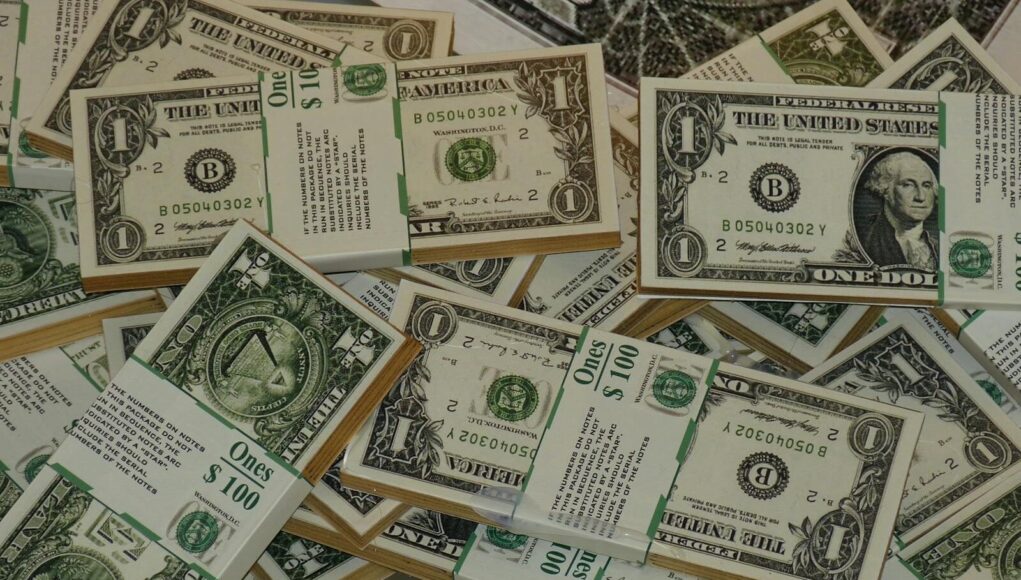 Numerous bundles of US one dollar bills symbolizing wealth, finance, and savings.