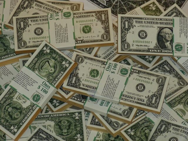 Photo by Pixabay Numerous bundles of US one dollar bills symbolizing wealth, finance, and savings.