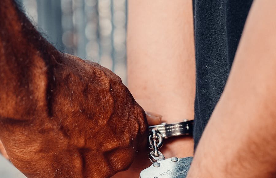 Detailed image of handcuffing arrest procedure, highlighting law enforcement action.