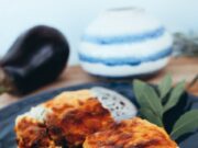 Žena iz Decoraha osumnjičena za trovanje trudnice lazanjom, pokrenuta istraga Savor the rich layers of vegetable lasagna on a sleek black plate with fresh garlic and potato garnish.