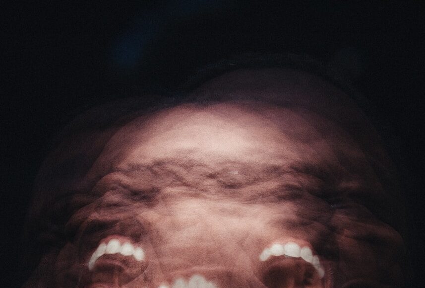 mans face with white scarf