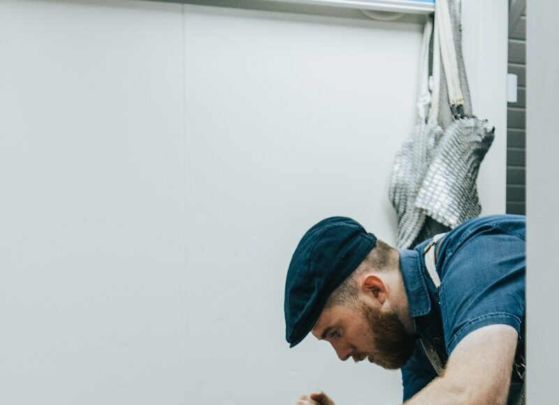 man in blue shirt slicing meat