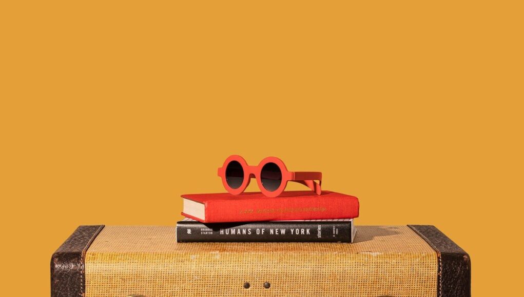 brown and black suitcase with red and yellow plastic toy