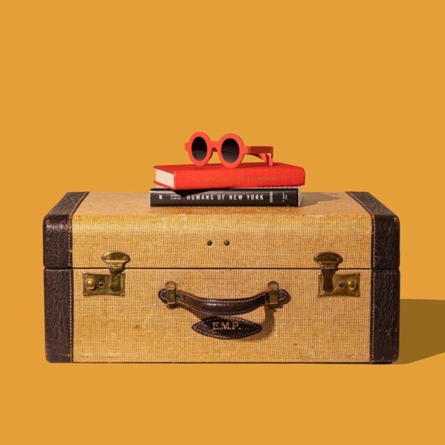 Photo by Shamblen Studios brown and black suitcase with red and yellow plastic toy
