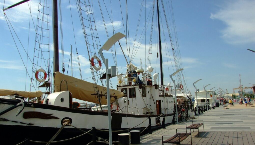 white and black boat on dock during daytime