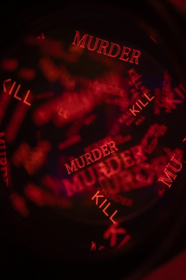 Photo by Andrey Soldatov Red words 'murder' and 'kill' repeated on dark background