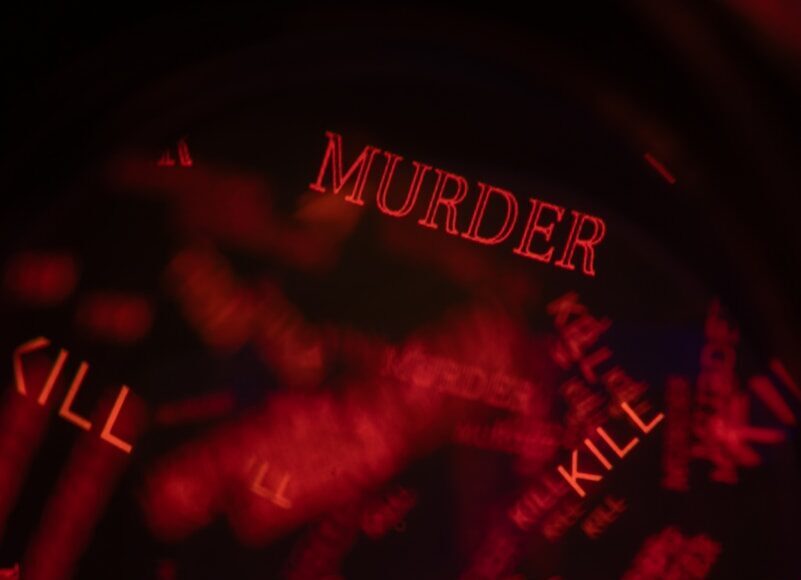 Photo by Andrey Soldatov Red words 'murder' and 'kill' repeated on dark background