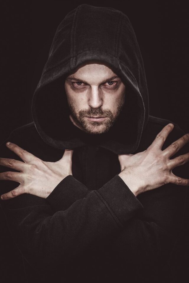 Photo by Sander Sammy man in black hoodie covering his face with his hand