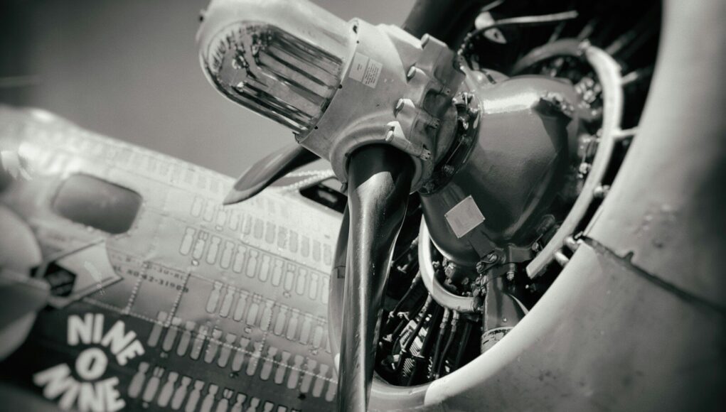 Photo by Robert Gourley grayscale photo of airplane engine