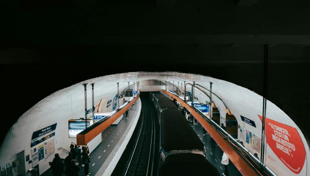 A busy Paris metro station captured with commuters waiting for their train.