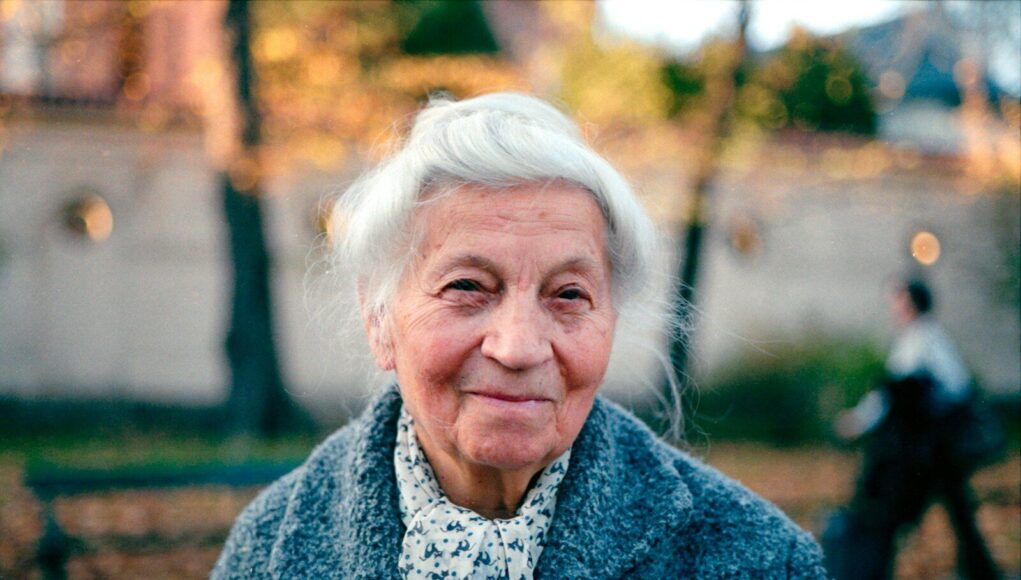 An old woman is walking down the street