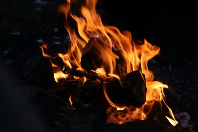 Photo by 𝑒𝑏𝑟𝑎𝑟 Vivid campfire flames creating warmth and light in a dark outdoor setting.