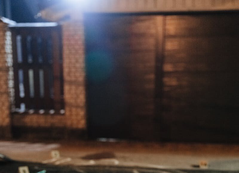 Photo by cottonbro studio Chalk outline and evidence markers at a crime scene outdoors at night.