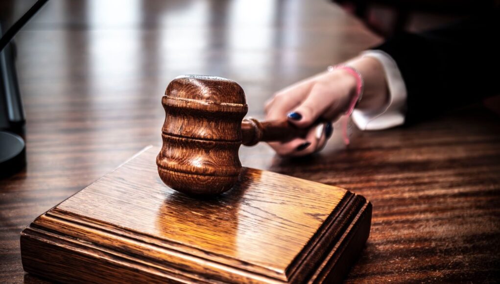 Photo by SHOX ART Close-up of a wooden gavel on a judge's desk, symbolizing justice.