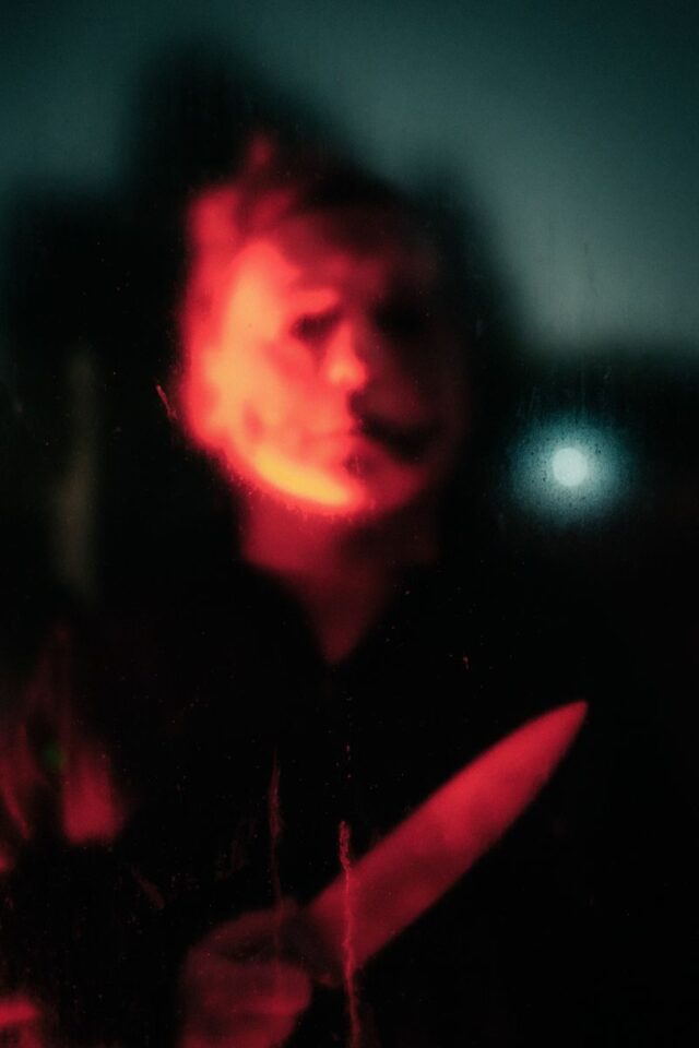 Photo by Nathan J Hilton Eerie silhouette with red lighting, reminiscent of a Halloween horror scene.