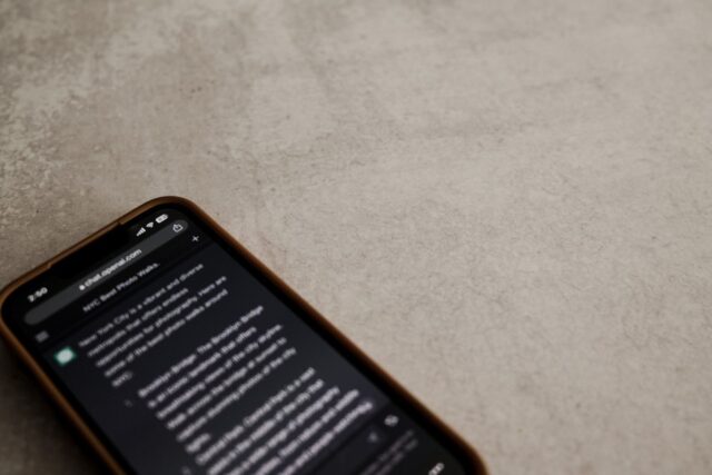 Photo by Airam Dato-on Close-up view of a smartphone displaying a chat interface on a textured surface.