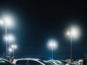 Automobil koji se pojavio na snimku: Trag koji je istražitelje odveo u drugom smeru A vivid night scene capturing a row of cars parked under bright streetlights in a spacious parking lot.
