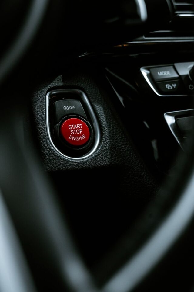 Photo by Anil Chandran Detailed view of a start stop engine button in a car interior, highlighting modern automotive design.