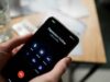 Jedan poziv promenio sve: Kako prevaranti uspevaju da ubede žrtve da im predaju novac Close-up of a person holding a smartphone, calling a depression hotline.